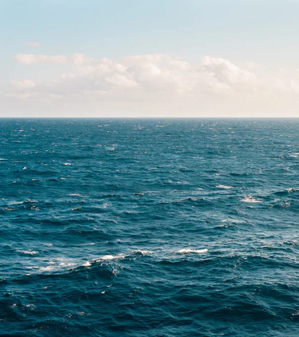 Blue seawater and waves beneath the horizon.