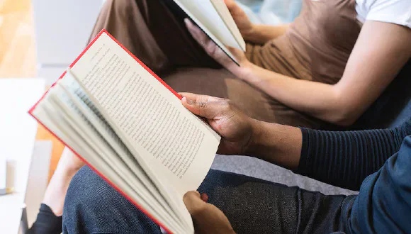 People holding and reading books.
