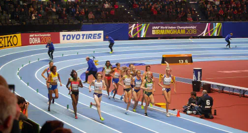 Runners competing on an indoor track in Birmingham in 2018.