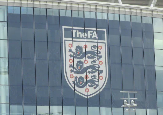 The FA logo on a glass-fronted building.