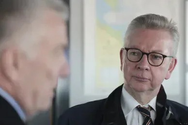 Michael Gove wearing glasses and an overcoat.