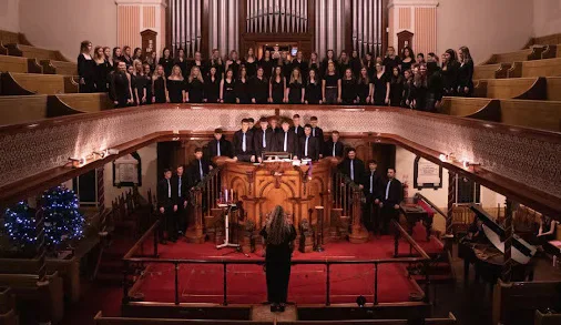 Aelwyd y Waun Ddyfal choirs performing in a church at Christmas.