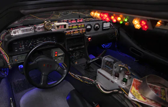 The illuminated dashboard and time controls inside a DeLorean car.