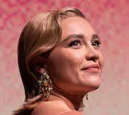 Florence Pugh looking upward at a public event.