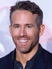 Actor Ryan Reynolds smiling at a public event.