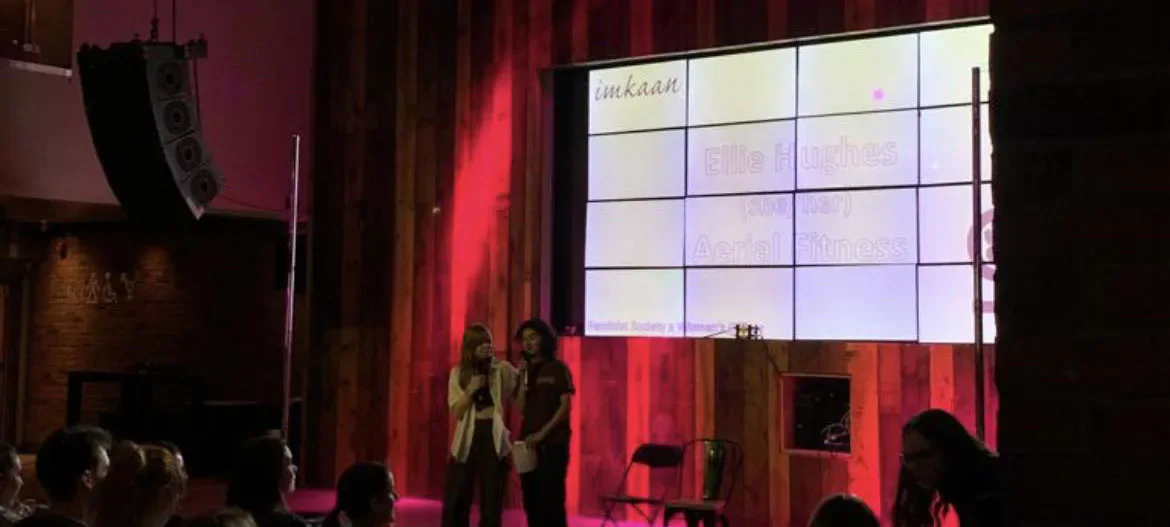 Performers speaking on stage during Cardiff University’s International Women’s Day showcase.