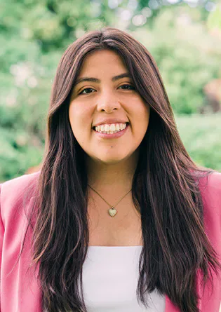 Angie Flores smiling outdoors.