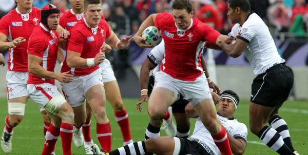 Wales rugby players carrying the ball against Fiji