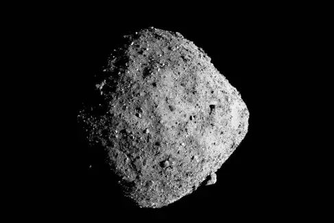Close-up image of the rocky asteroid Bennu against a black background