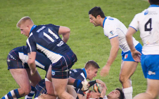 Rugby players contesting the ball during a match