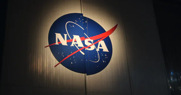 The NASA insignia mounted on a dark wall