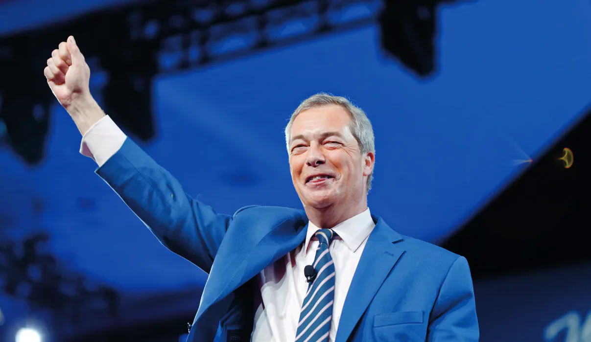 Nigel Farage waving on a stage