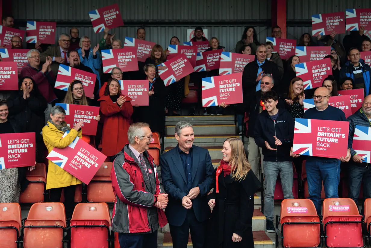 Keir Starmer with Labour by-election campaigners holding red signs