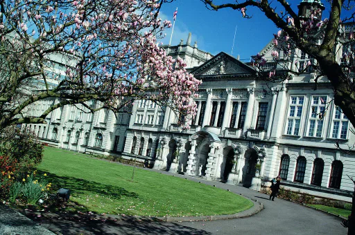Cardiff University Main Building framed by flowering trees