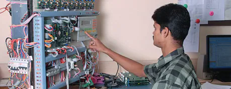 Technician working on electrical control equipment