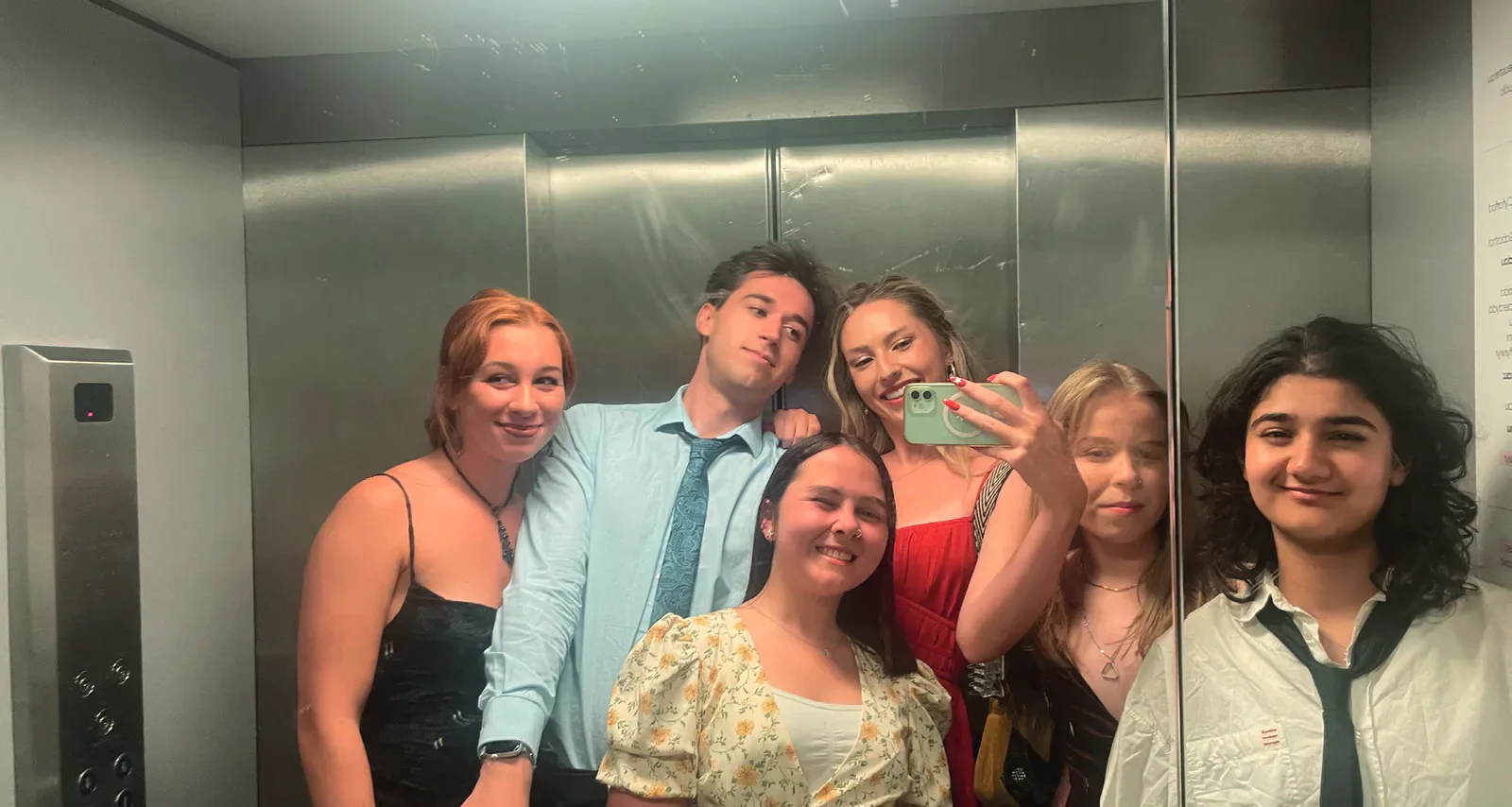 Students posing for a group mirror photograph