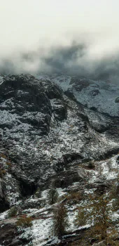 Snow-covered mountain landscape beneath low cloud