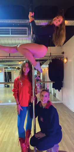 Members of Cardiff University aerial fitness society posing on poles