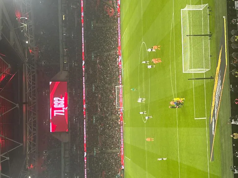 Lionesses players celebrating together on the pitch at Wembley