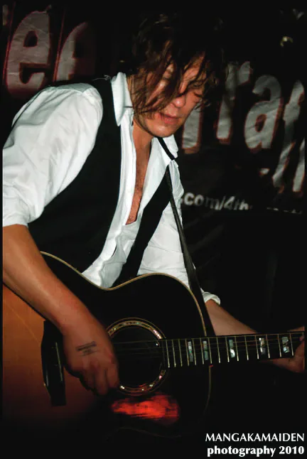 A musician playing guitar at Clwb Ifor Bach.