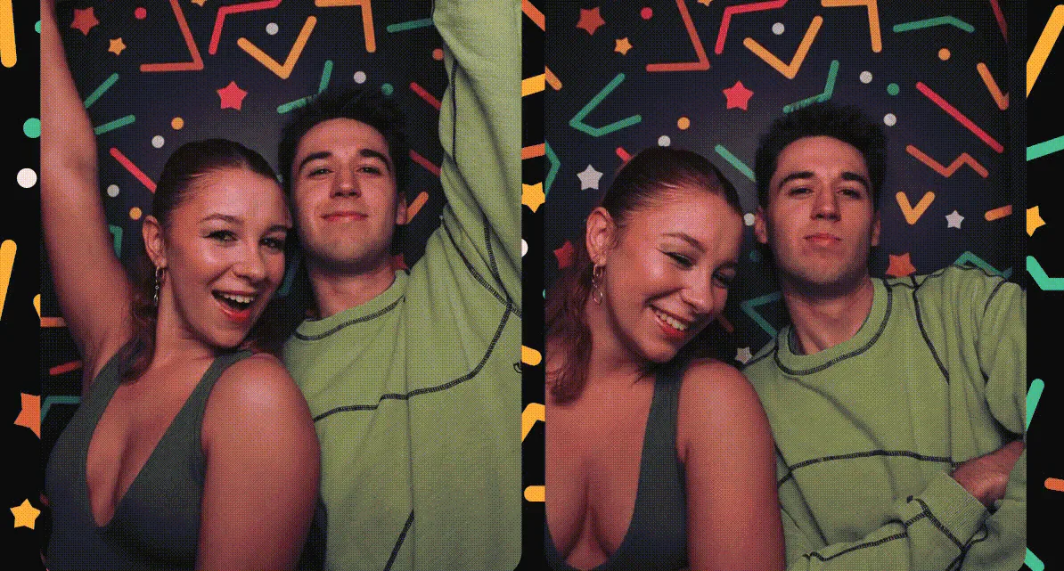 Two students posing together against a colourful geometric backdrop.