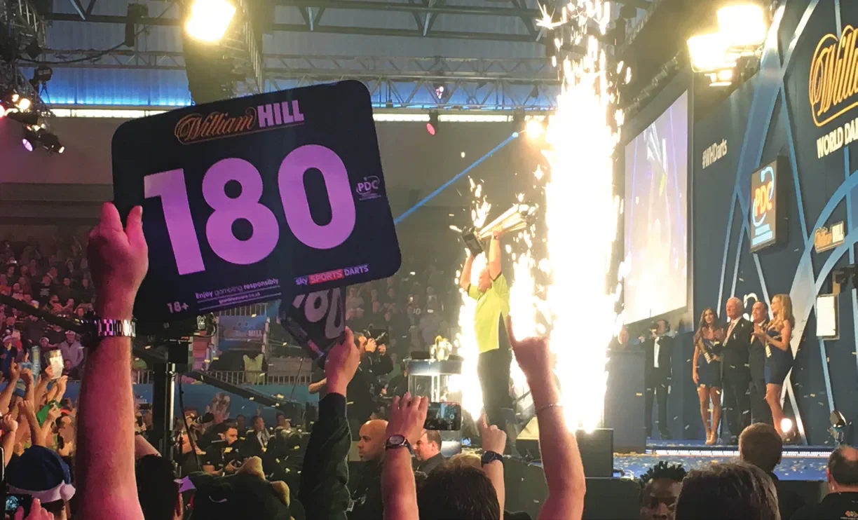 A fan holds a 180 sign at Premier League Darts in Cardiff.