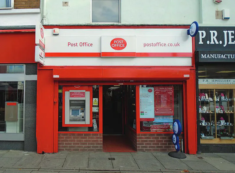 A Post Office branch with a red storefront.