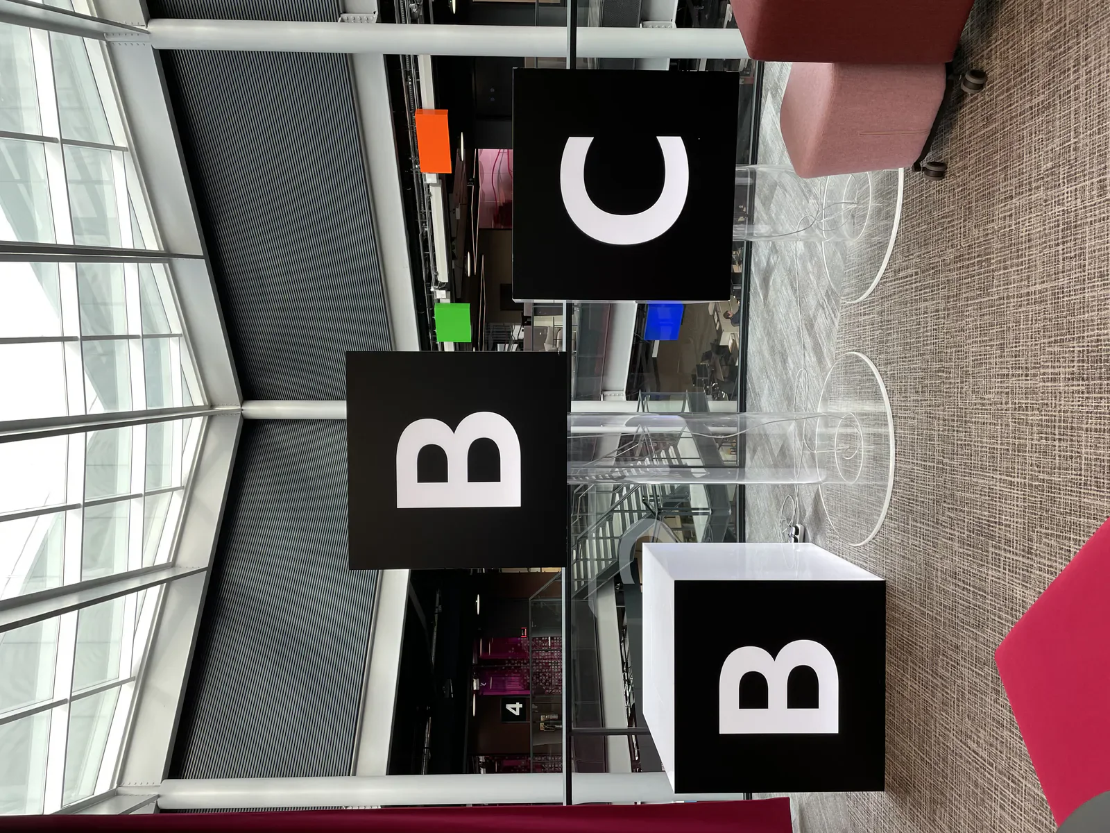 BBC logo signs inside a modern BBC building.