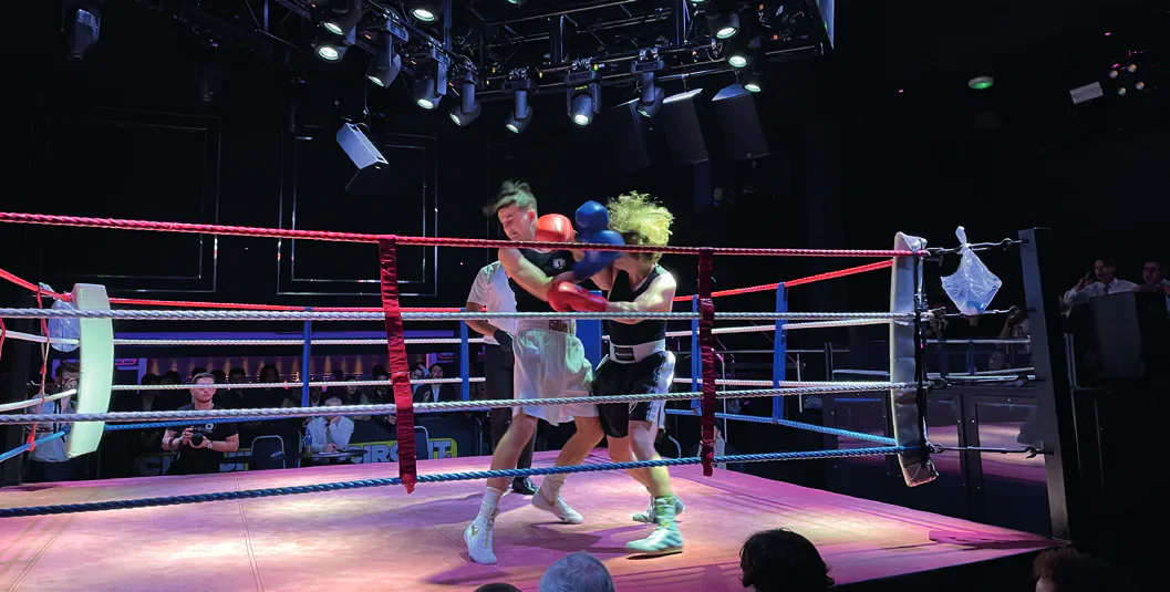 Two amateur boxers compete in a boxing ring during CUABC Fight Night.