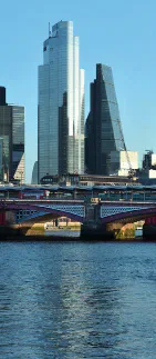 Modern office towers beside the River Thames in London.