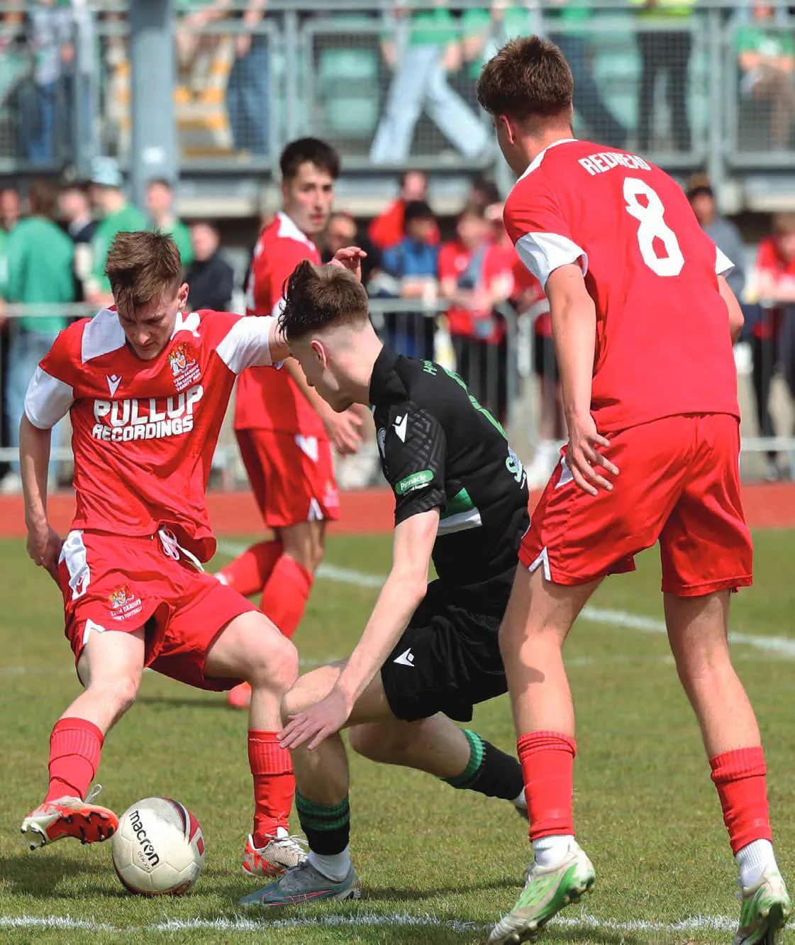 Cardiff and Swansea football players contesting the ball