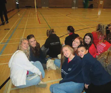 Spectators seated beside the indoor netball court
