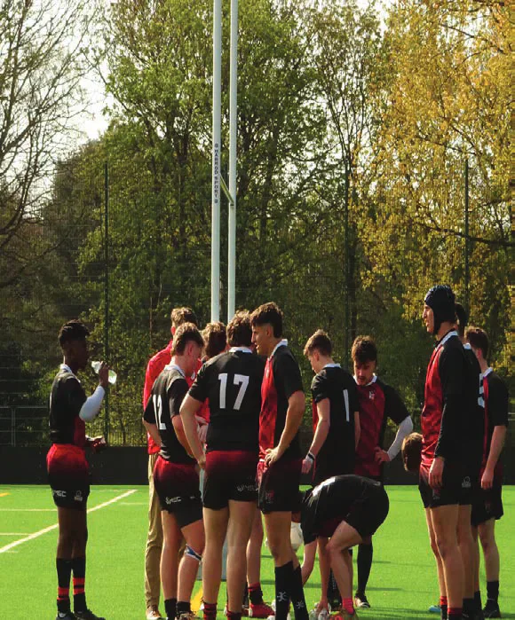 Cardiff rugby league players gathered beside the pitch
