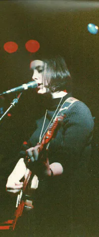 Slowdive guitarist and vocalist performing on stage