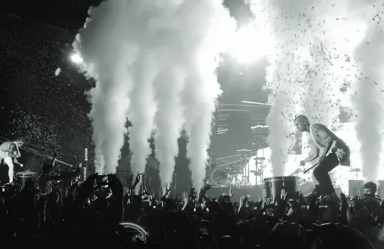 Twenty One Pilots performing amid smoke and confetti