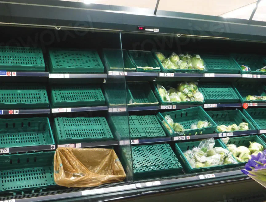 Mostly empty supermarket produce shelves