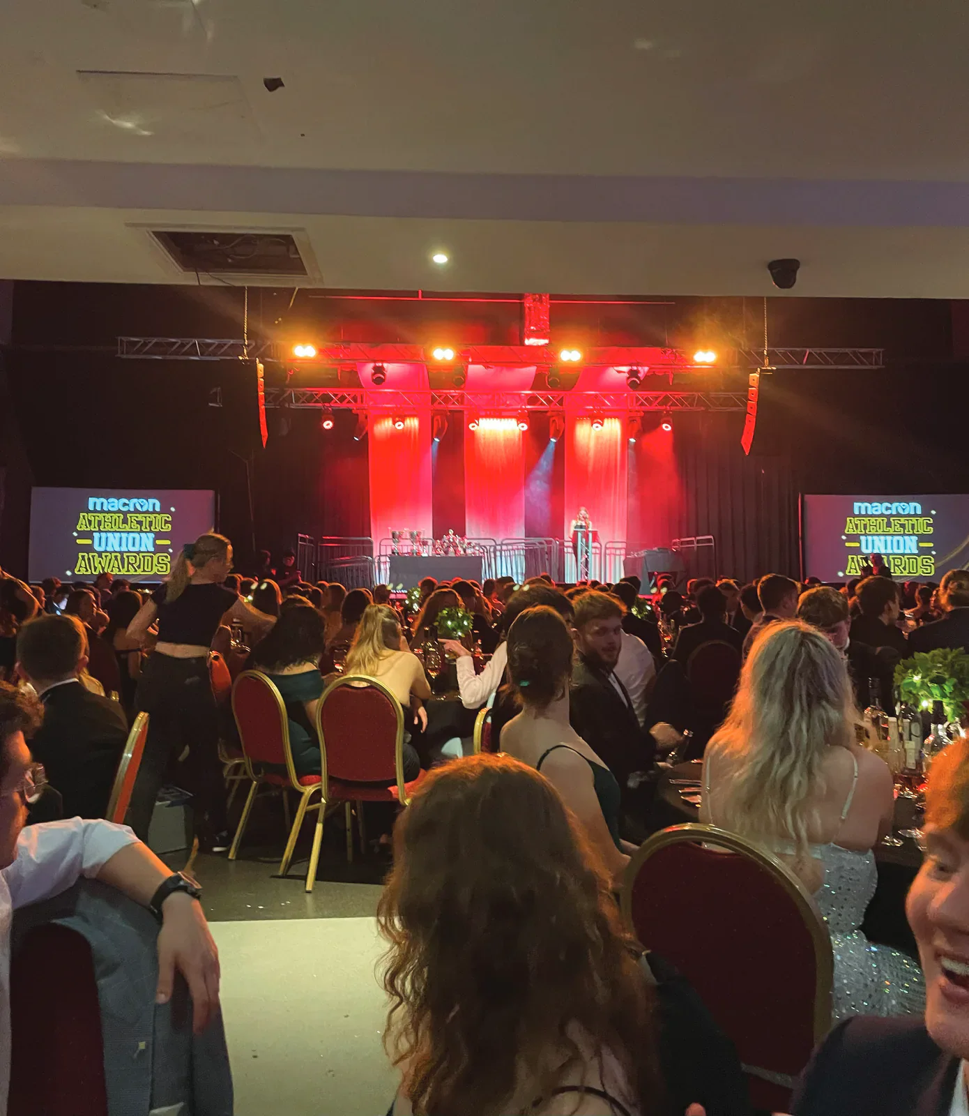 Athletic Union Awards stage viewed across seated guests