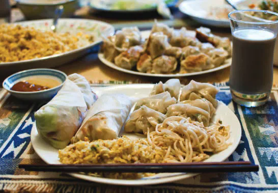 Bowls and plates of buffet food
