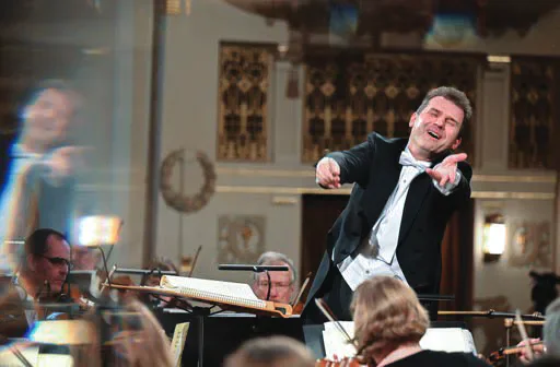 Tomáš Hanus conducting an orchestra