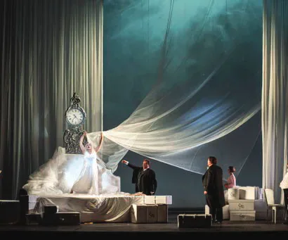 Welsh National Opera production on a bedroom stage set