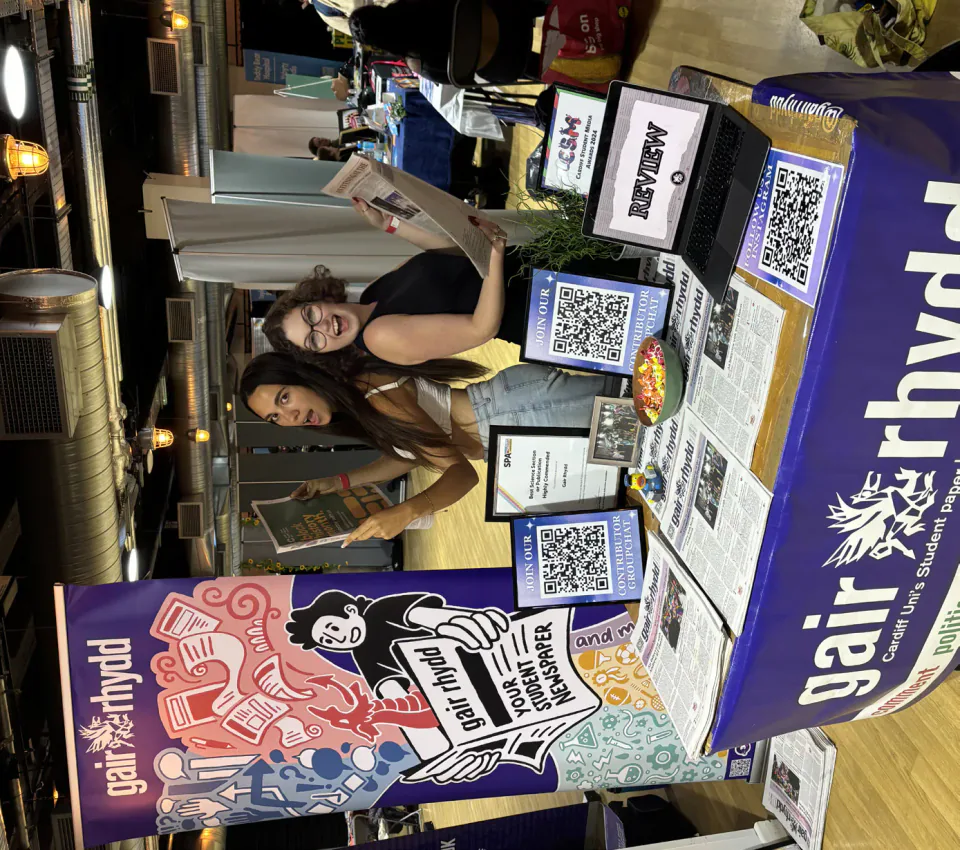 Two Gair Rhydd team members at the newspaper’s Freshers’ Fair stand.