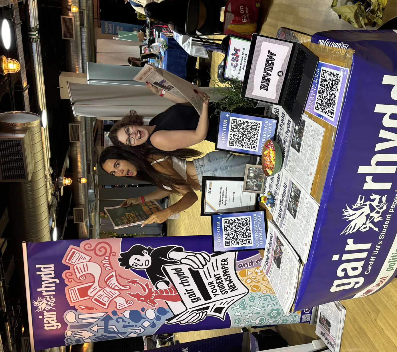 Two Gair Rhydd team members at the newspaper’s Freshers’ Fair stand.