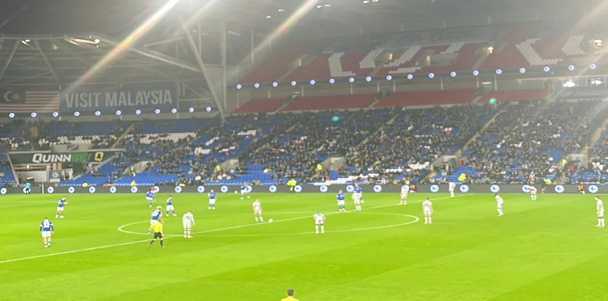 Cardiff City playing Millwall under floodlights at Cardiff City Stadium.