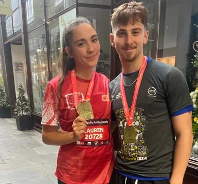 Lauren and another Cardiff Half Marathon finisher holding their medals.