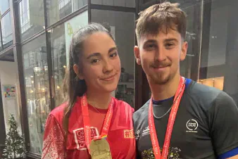 Lauren and another Cardiff Half Marathon finisher holding their medals.