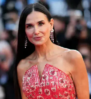 Demi Moore wearing a red patterned gown at the Cannes Film Festival.