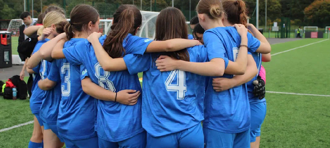 Cardiff University Ladies Football players in a pre-match team huddle.