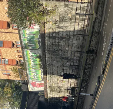 A railway bridge and stone wall in Cathays.