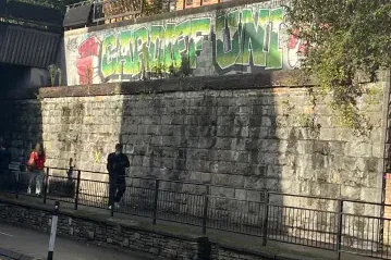 A railway bridge and stone wall in Cathays.
