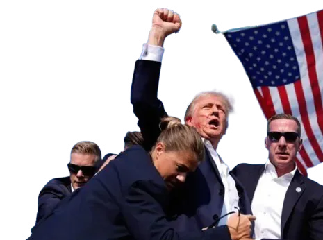 Donald Trump raises his fist while surrounded by security personnel beneath a US flag.